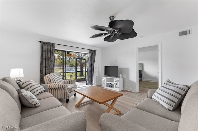 living room featuring ceiling fan and light hardwood / wood-style floors