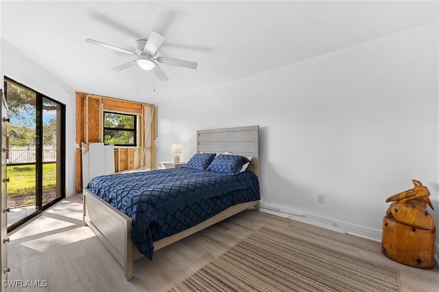 bedroom with access to outside, light hardwood / wood-style floors, and ceiling fan