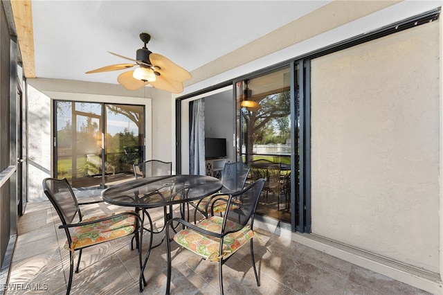 sunroom / solarium featuring ceiling fan