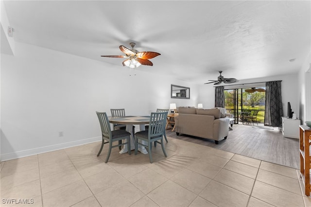 dining area featuring ceiling fan and light tile patterned floors