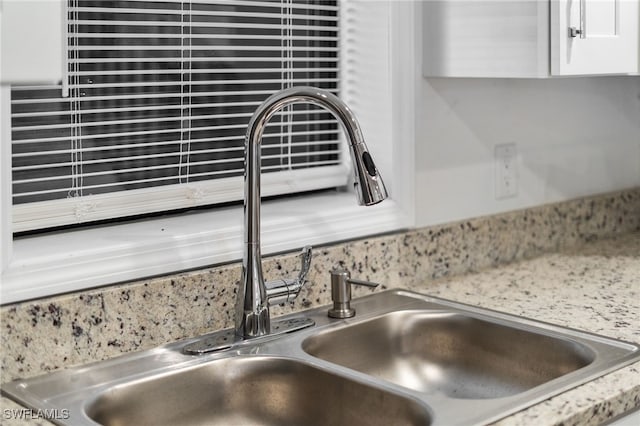 room details featuring sink and white cabinets