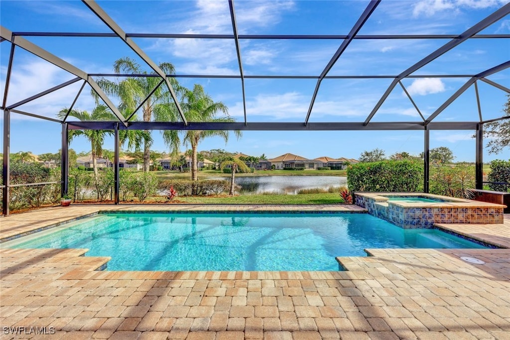 view of swimming pool with a water view, an in ground hot tub, a lanai, and a patio area