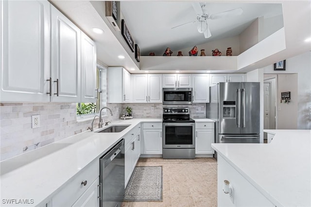 kitchen featuring white cabinetry, lofted ceiling, stainless steel appliances, and sink