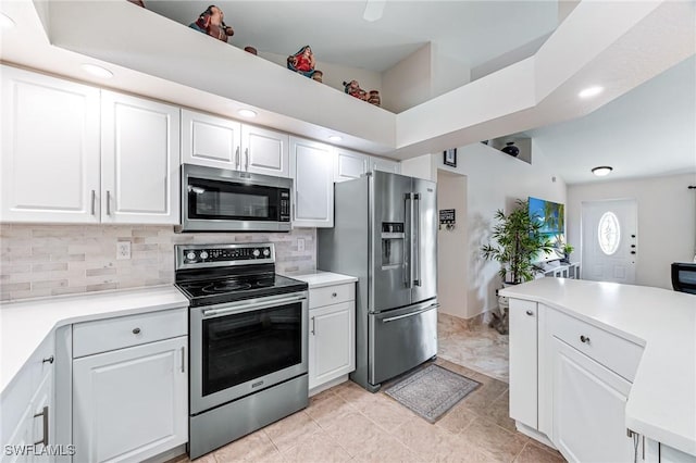 kitchen with stainless steel appliances, white cabinetry, and decorative backsplash