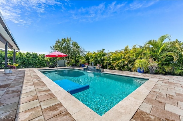 view of swimming pool with pool water feature and a patio area