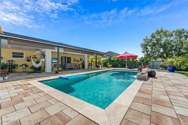 view of pool with pool water feature and a patio area