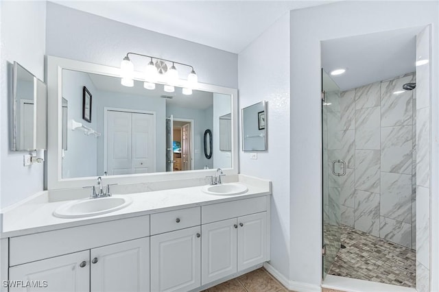 bathroom featuring walk in shower, vanity, and tile patterned flooring