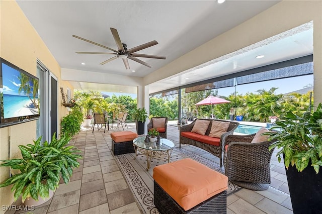 sunroom featuring ceiling fan