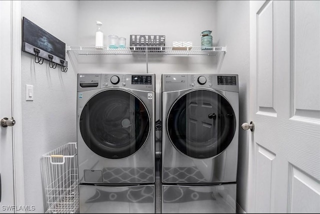 laundry room with washing machine and dryer