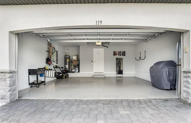 garage featuring a garage door opener and electric water heater