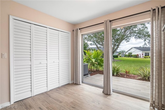 doorway to outside with light hardwood / wood-style floors and a healthy amount of sunlight