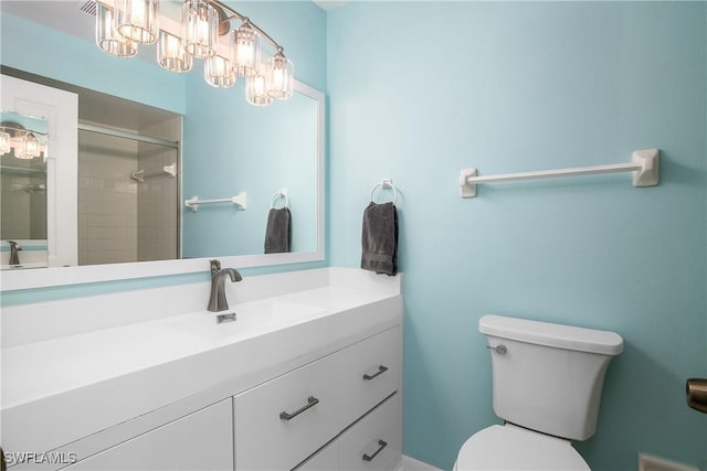 bathroom featuring vanity, toilet, and walk in shower