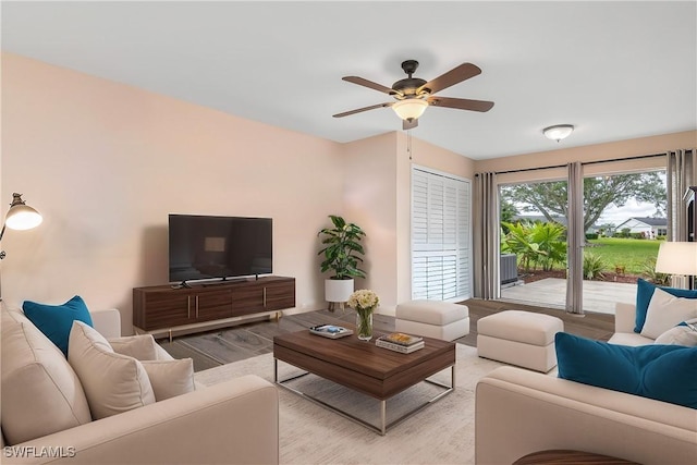 living room featuring ceiling fan and light hardwood / wood-style flooring