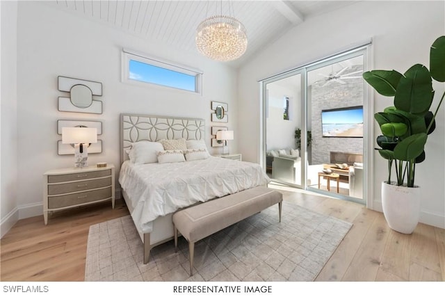 bedroom with baseboards, a notable chandelier, lofted ceiling with beams, and light wood finished floors