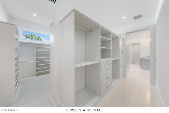 spacious closet featuring visible vents