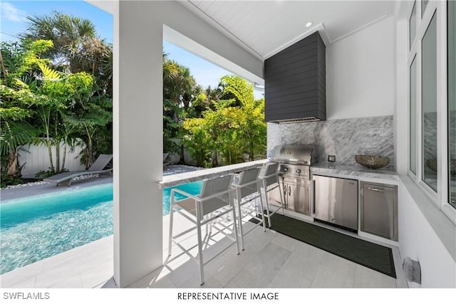 view of patio / terrace featuring fence, a fenced in pool, and area for grilling