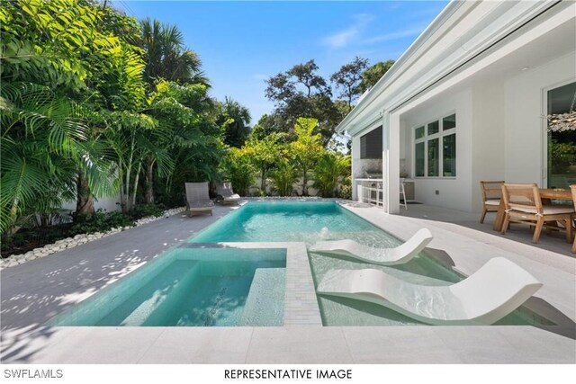 pool featuring outdoor dining area and a patio