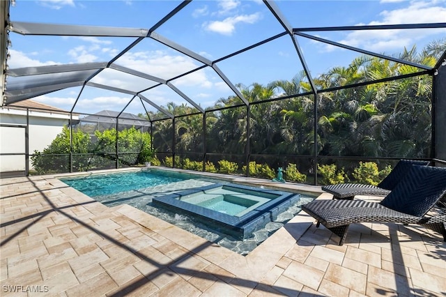 view of pool with a lanai, a patio, and an in ground hot tub