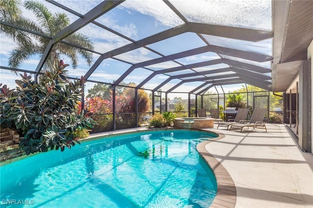 view of swimming pool with a lanai, a patio, and an in ground hot tub