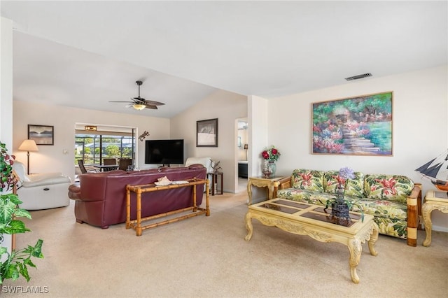 living room featuring ceiling fan, lofted ceiling, and carpet floors