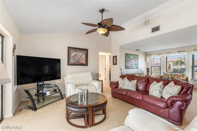 living room featuring lofted ceiling, light colored carpet, and ceiling fan