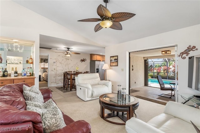 living room featuring ceiling fan, lofted ceiling, and light carpet