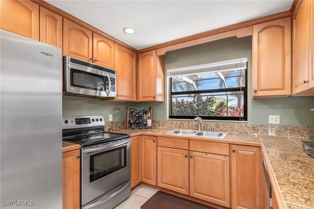 kitchen featuring light tile patterned flooring, appliances with stainless steel finishes, and sink