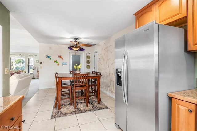 dining room with light carpet and ceiling fan