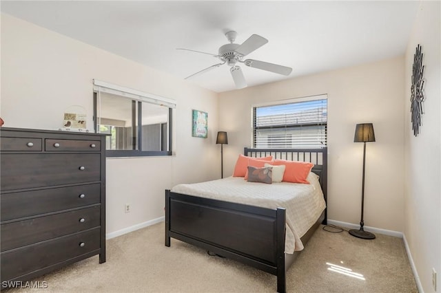 carpeted bedroom with multiple windows and ceiling fan