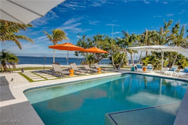 view of swimming pool with a patio and a water view