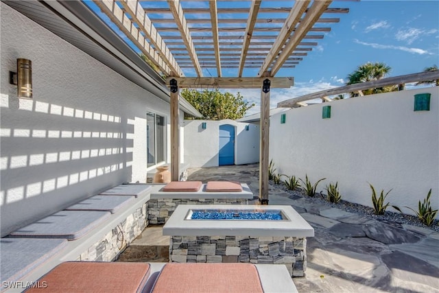 view of patio with a pergola and an outdoor fire pit