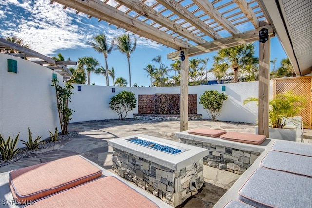 view of patio / terrace with a pergola and an outdoor fire pit