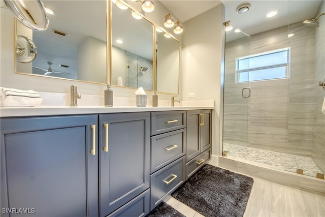 bathroom featuring vanity and a shower with shower door