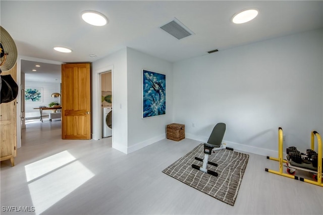 exercise room featuring washer / dryer