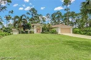 view of front of home with a garage and a front yard