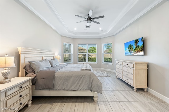 bedroom with a tray ceiling, ornamental molding, and ceiling fan