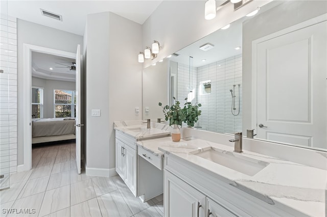 bathroom with an enclosed shower, vanity, and ceiling fan