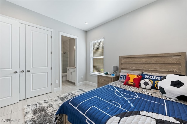 bedroom featuring ensuite bathroom and a closet