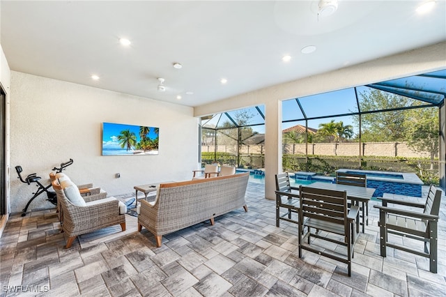 view of patio / terrace with a swimming pool with hot tub, pool water feature, an outdoor hangout area, ceiling fan, and glass enclosure