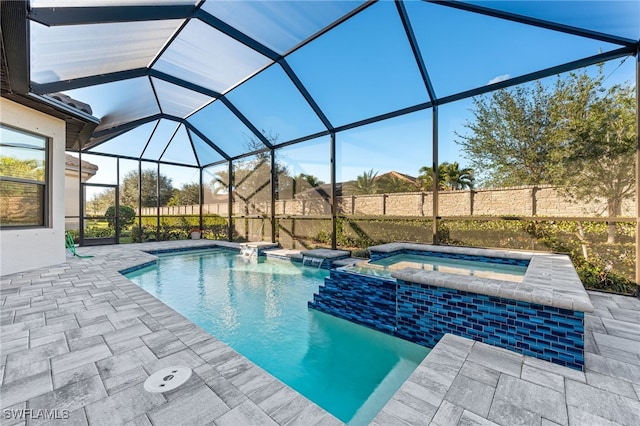 view of pool featuring a lanai, a patio area, pool water feature, and an in ground hot tub