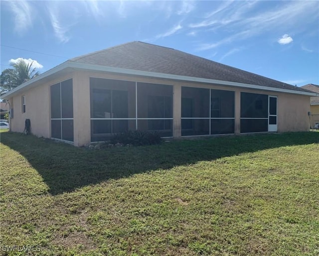 rear view of property featuring a yard