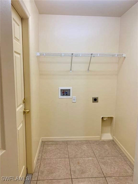 clothes washing area featuring hookup for a washing machine, light tile patterned flooring, and electric dryer hookup