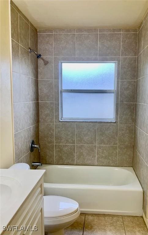 full bathroom with vanity, tile patterned flooring, toilet, and tiled shower / bath