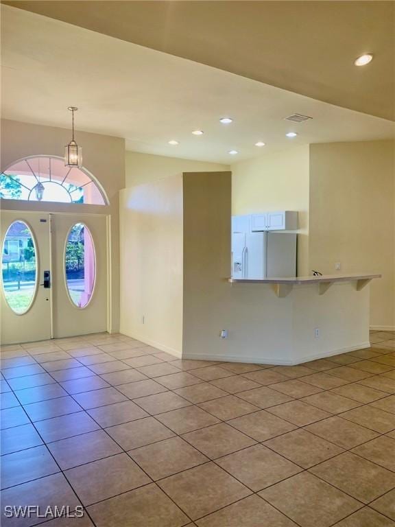 entryway with light tile patterned floors