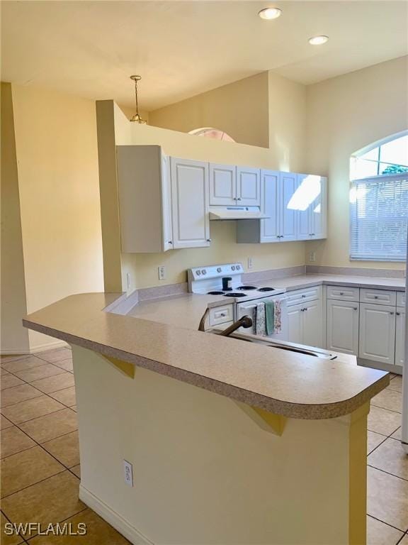 kitchen with a breakfast bar, kitchen peninsula, and hanging light fixtures