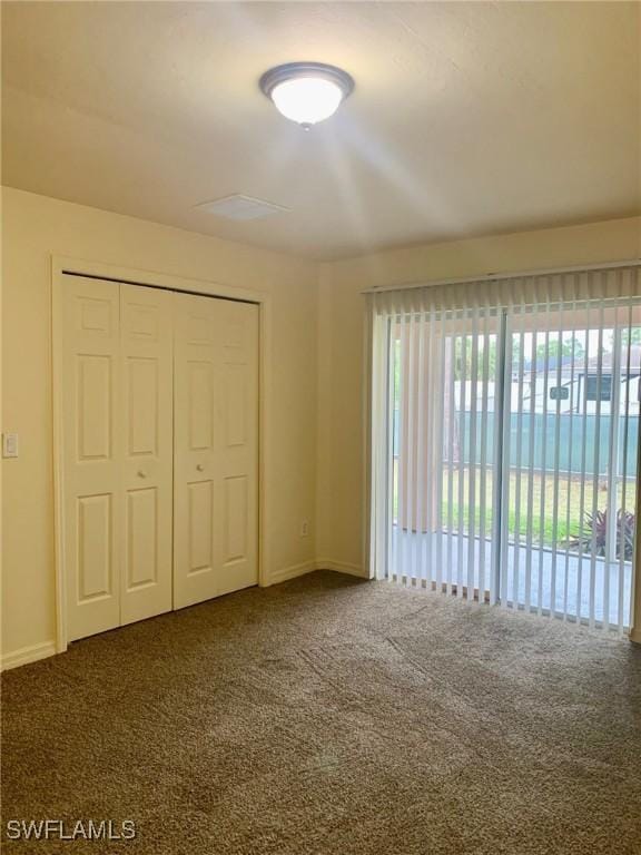 unfurnished bedroom with a closet and carpet