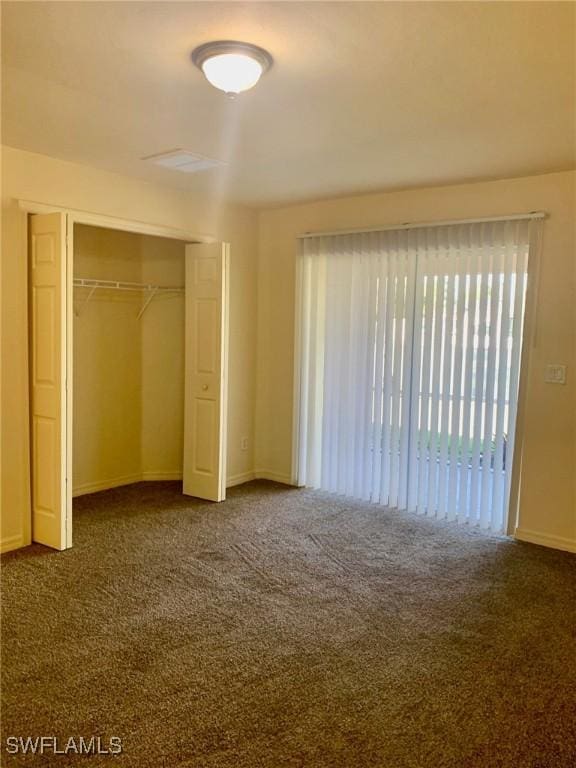 unfurnished bedroom featuring a closet and carpet