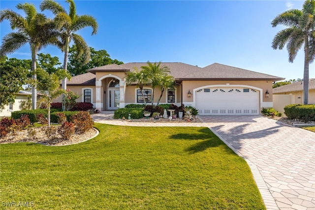 view of front of property with a garage and a front yard