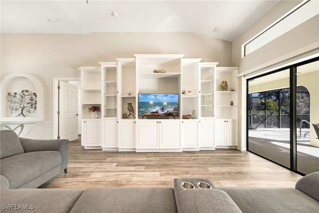 living room with vaulted ceiling and light hardwood / wood-style floors