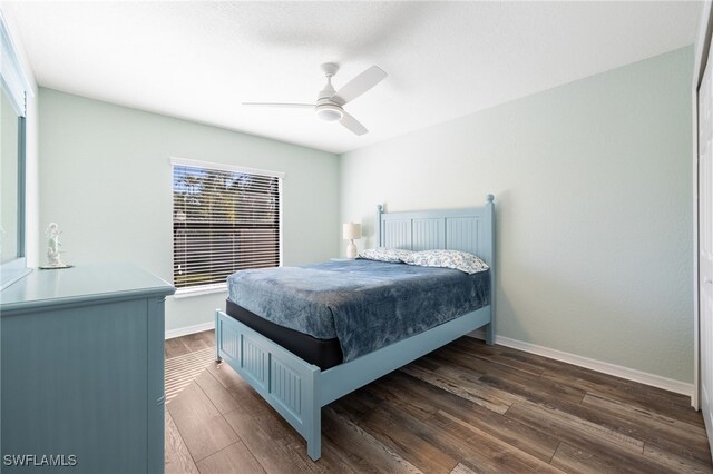 bedroom with ceiling fan and dark hardwood / wood-style flooring